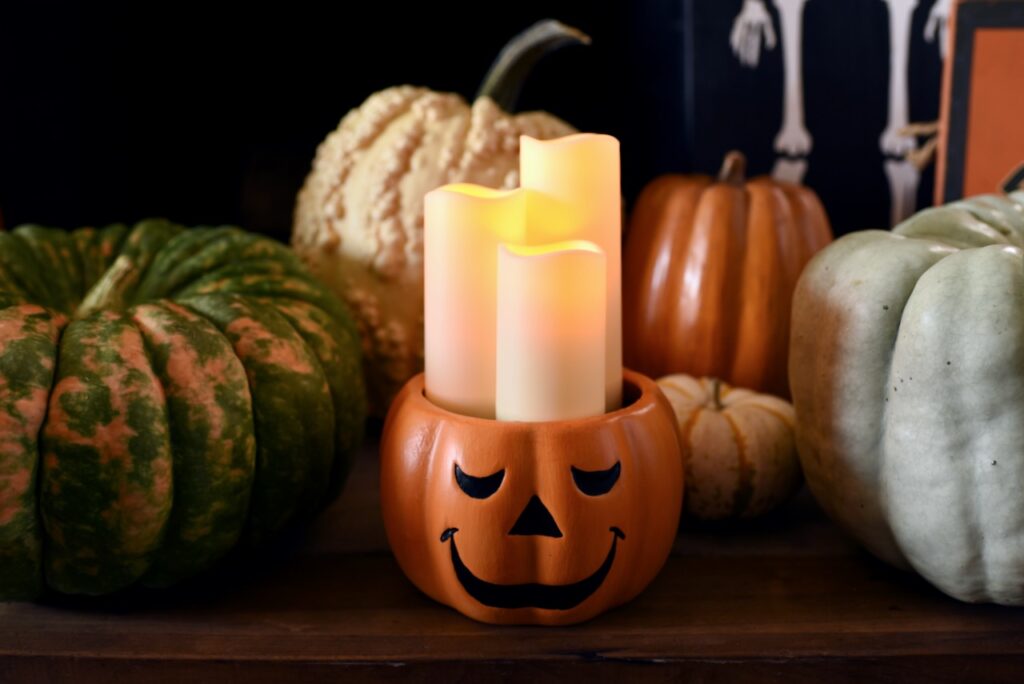 light up pumpkin with three white candles inside