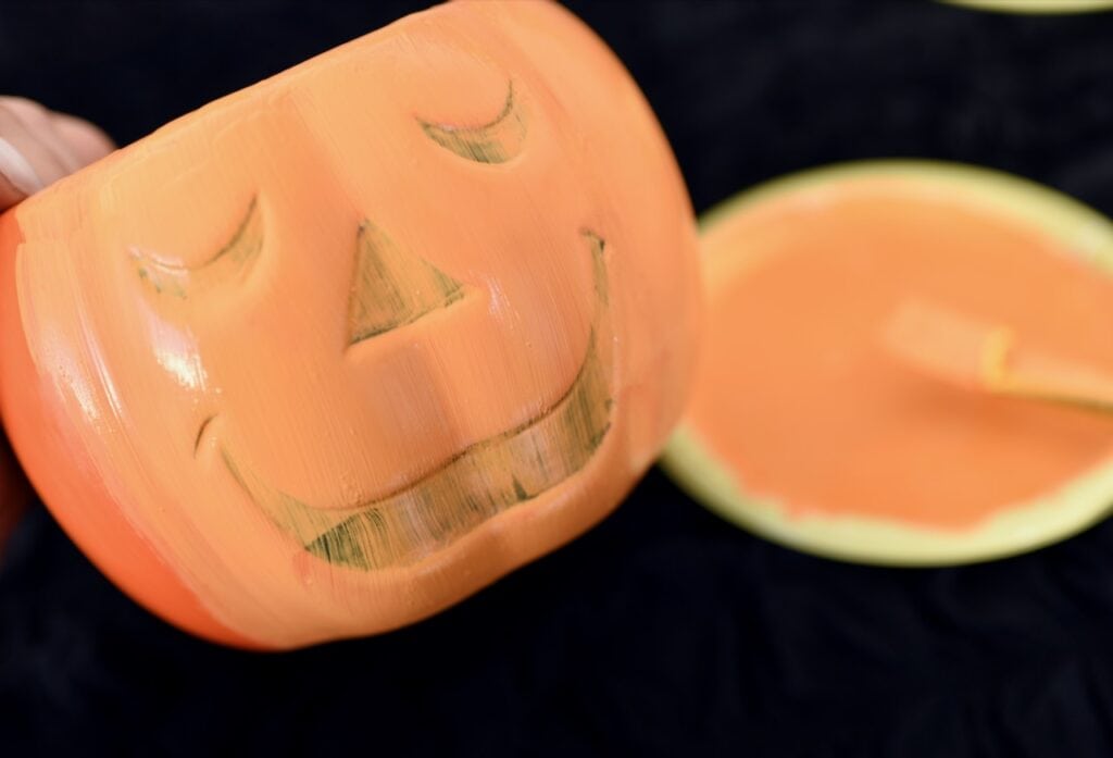 orange jack o' lantern with wet orange paint