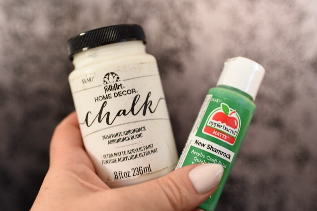 white chalk paint bottle next to green acrylic paint