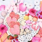 valentine dessert board with read, pink, and white candy and cookies